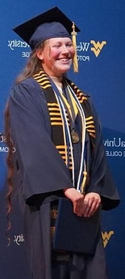 a student posing in her graduation robes